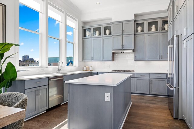 201 Carroll St, Fort Worth, TX 76107 - kitchen with stainless steel appliances, gray cabinetry, dark wood-style flooring, tasteful backsplash, and crown molding