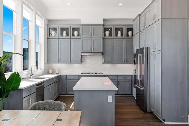 201 Carroll St, Fort Worth, TX 76107 - kitchen featuring gray cabinets, stainless steel appliances, a kitchen island, backsplash, and crown molding