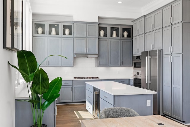 201 Carroll St, Fort Worth, TX 76107 - kitchen featuring appliances with stainless steel finishes, gray cabinets, light countertops, backsplash, and recessed lighting