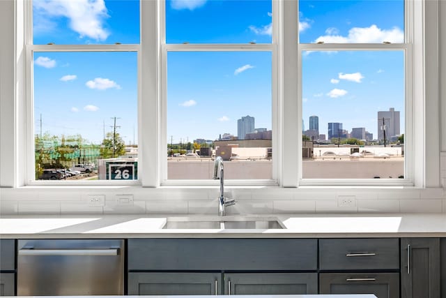 201 Carroll St, Fort Worth, TX 76107 - kitchen with a sink, gray cabinets, stainless steel dishwasher, and light countertops