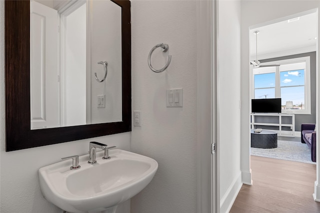 201 Carroll St, Fort Worth, TX 76107 - bathroom with a sink, wood finished floors, and baseboards