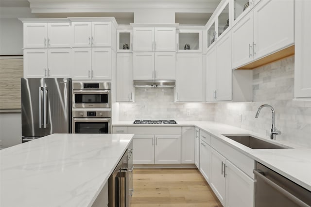 1460 N Ave, Plano, TX 75074 - kitchen featuring stainless steel appliances, a sink, light wood-type flooring, white cabinetry, and light stone countertops