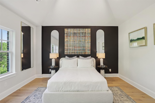 1460 N Ave, Plano, TX 75074 - bedroom with lofted ceiling, light wood finished floors, and baseboards