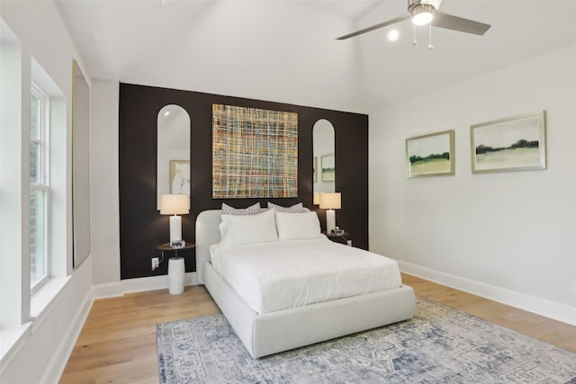 1460 N Ave, Plano, TX 75074 - bedroom featuring light wood-type flooring, baseboards, arched walkways, a ceiling fan, and high vaulted ceiling