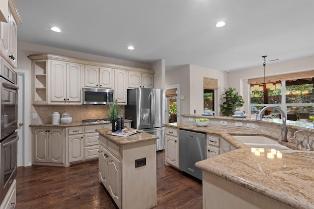 1817 Foxborough Trl, Flower Mound, TX 75028 - kitchen featuring stainless steel appliances, a sink, tasteful backsplash, a kitchen island, and dark wood-style flooring