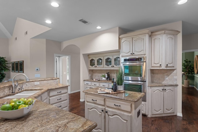 1817 Foxborough Trl, Flower Mound, TX 75028 - kitchen featuring stainless steel double oven, a sink, decorative backsplash, a kitchen island, and cream cabinets