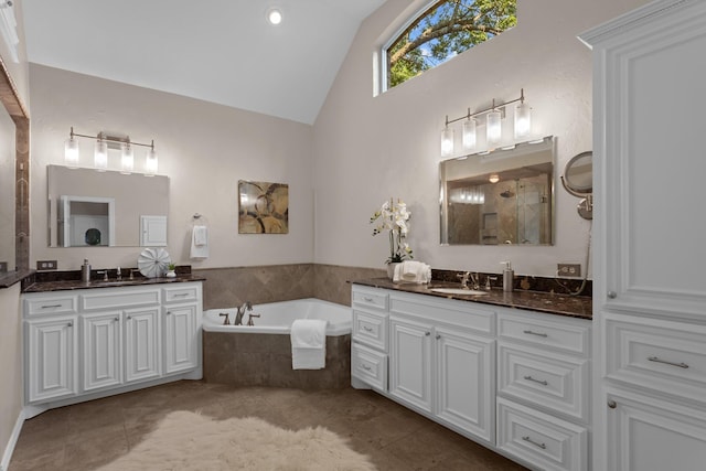 1817 Foxborough Trl, Flower Mound, TX 75028 - bathroom featuring two vanities, a bath, tile patterned floors, a tile shower, and high vaulted ceiling