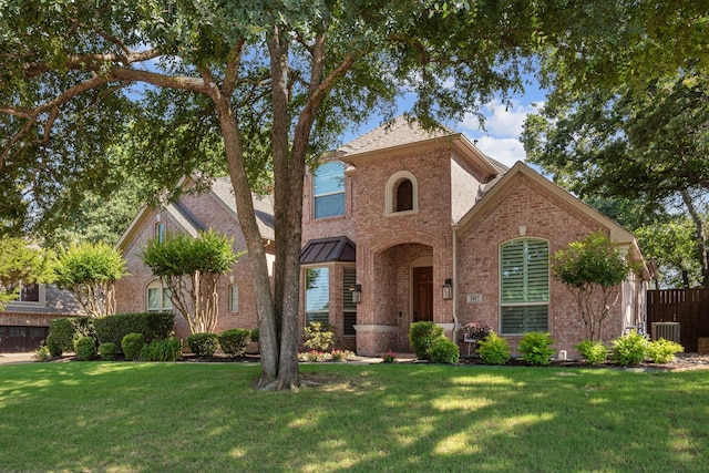 1817 Foxborough Trl, Flower Mound, TX 75028 - view of front facade featuring brick siding, a front yard, and central AC unit