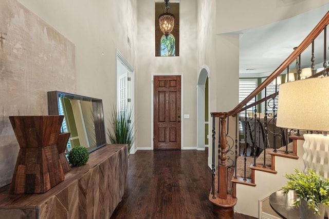 1817 Foxborough Trl, Flower Mound, TX 75028 - foyer entrance featuring a high ceiling, wood finished floors, arched walkways, stairway, and baseboards