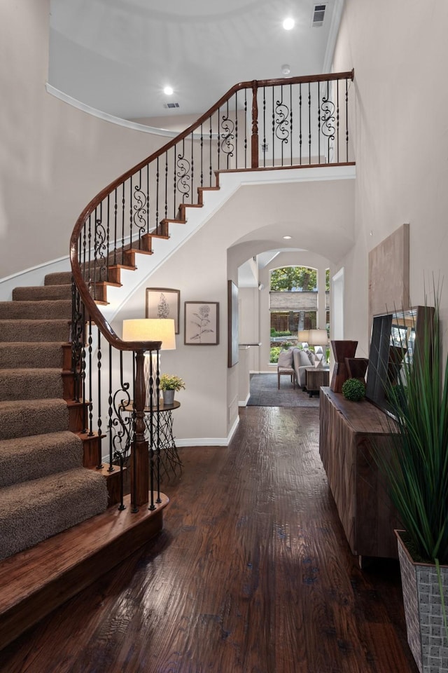 1817 Foxborough Trl, Flower Mound, TX 75028 - stairs with arched walkways, baseboards, wood finished floors, a towering ceiling, and recessed lighting