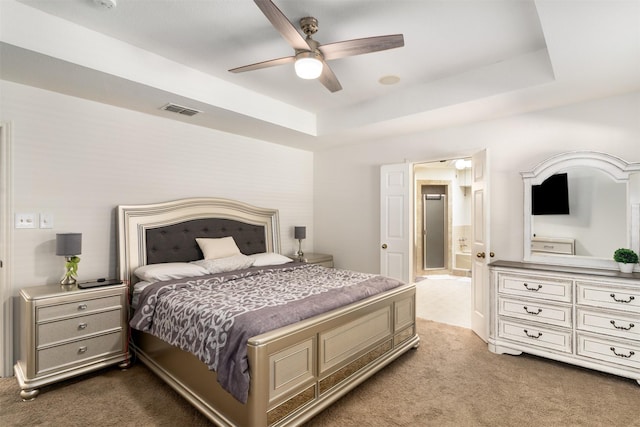 529 Doubletree Dr, Highland Village, TX 75077 - bedroom featuring dark carpet, a tray ceiling, ensuite bath, and a ceiling fan