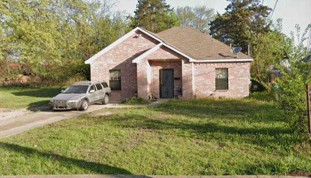 3303 Springview Ave, Dallas, TX 75216 - view of front facade featuring a front lawn, brick siding, and driveway