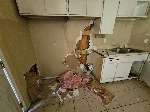 3303 Springview Ave, Dallas, TX 75216 - kitchen with tile patterned floors, a sink, light countertops, and white cabinets