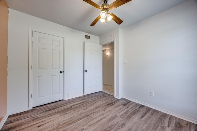 505 W Thomas St, Leonard, TX 75452 - unfurnished bedroom featuring wood finished floors, baseboards, and a ceiling fan