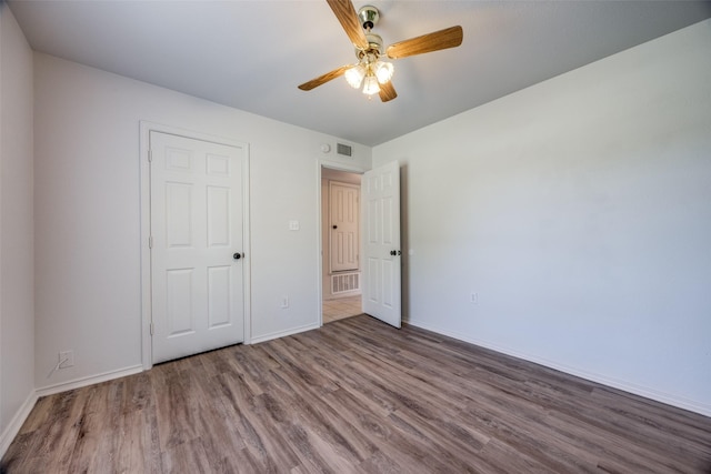 505 W Thomas St, Leonard, TX 75452 - unfurnished bedroom featuring wood finished floors, baseboards, and a ceiling fan
