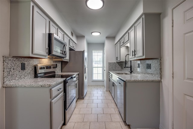 505 W Thomas St, Leonard, TX 75452 - kitchen featuring appliances with stainless steel finishes, a sink, tasteful backsplash, gray cabinets, and light tile patterned flooring