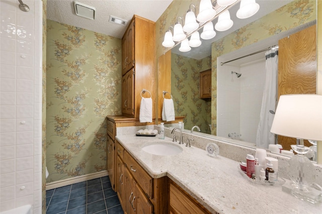 2818 Summit Ridge St, Grapevine, TX 76051 - full bath with tile patterned flooring, vanity, wallpapered walls, baseboards, and a textured ceiling