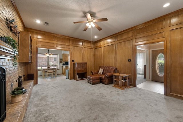 2818 Summit Ridge St, Grapevine, TX 76051 - living room featuring a ceiling fan, light carpet, wooden walls, and a textured ceiling