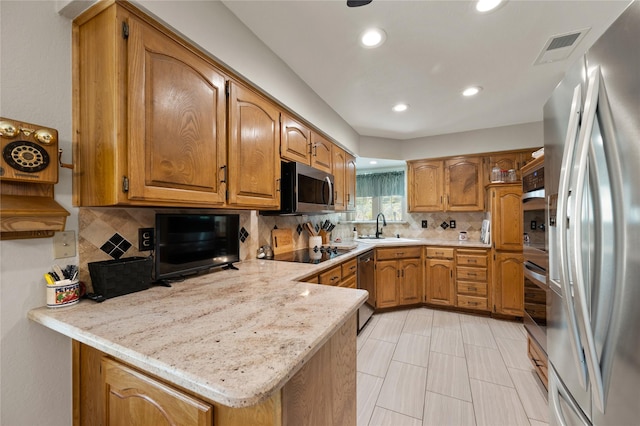 2818 Summit Ridge St, Grapevine, TX 76051 - kitchen with stainless steel appliances, light countertops, recessed lighting, backsplash, and a sink