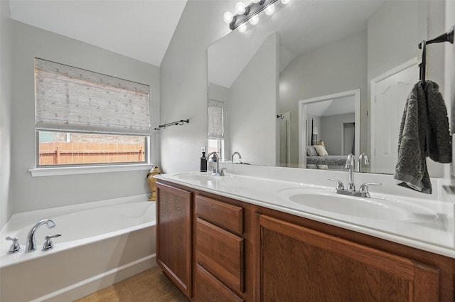 1414 Fox Glen Trl, Mansfield, TX 76063 - bathroom with double vanity, tile patterned floors, a bath, lofted ceiling, and ensuite bathroom