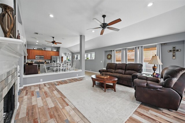 1414 Fox Glen Trl, Mansfield, TX 76063 - living area featuring a ceiling fan, vaulted ceiling, a fireplace, light wood-style flooring, and recessed lighting