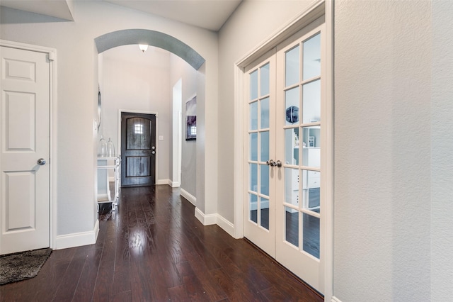 1317 Roadrunner Dr, Little Elm, TX 75068 - hall featuring arched walkways, french doors, wood finished floors, and baseboards