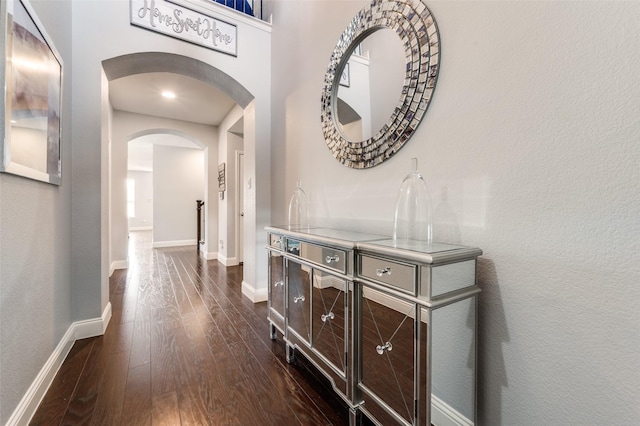 1317 Roadrunner Dr, Little Elm, TX 75068 - hallway with arched walkways, dark wood finished floors, and baseboards