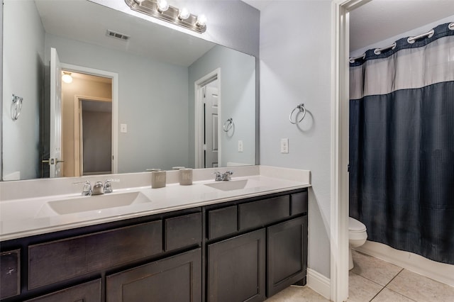 1317 Roadrunner Dr, Little Elm, TX 75068 - bathroom with toilet, double vanity, and tile patterned flooring