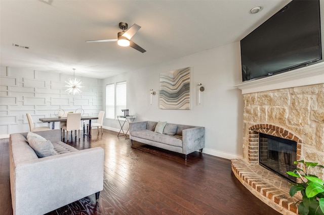 1317 Roadrunner Dr, Little Elm, TX 75068 - living area with baseboards, ceiling fan, a fireplace with raised hearth, and dark wood finished floors