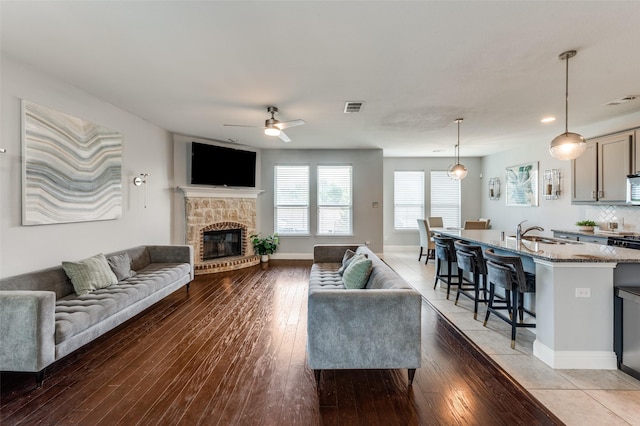 1317 Roadrunner Dr, Little Elm, TX 75068 - living area with a ceiling fan, light wood finished floors, a glass covered fireplace, baseboards, and recessed lighting
