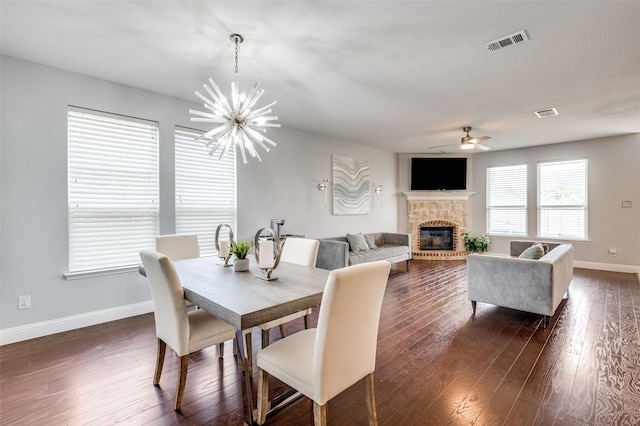 1317 Roadrunner Dr, Little Elm, TX 75068 - dining area featuring a ceiling fan, baseboards, a glass covered fireplace, a chandelier, and dark wood finished floors