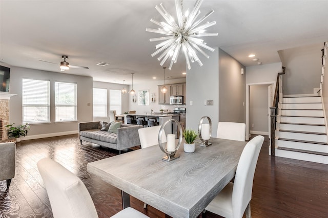 1317 Roadrunner Dr, Little Elm, TX 75068 - dining space with a chandelier, stairs, dark wood finished floors, a ceiling fan, and baseboards
