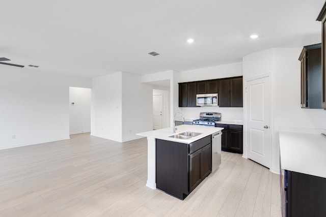 1932 Coleto Rd, Crandall, TX 75114 - kitchen with appliances with stainless steel finishes, open floor plan, a sink, light wood-style flooring, and recessed lighting