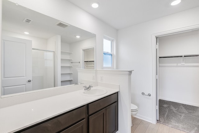1932 Coleto Rd, Crandall, TX 75114 - bathroom with a spacious closet, vanity, toilet, a stall shower, and recessed lighting