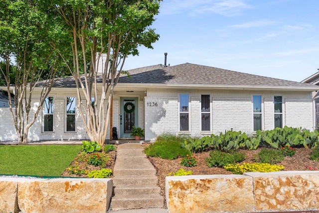 1236 Richland Oaks Dr, Richardson, TX 75081 - view of front of home featuring a shingled roof, brick siding, and a front yard