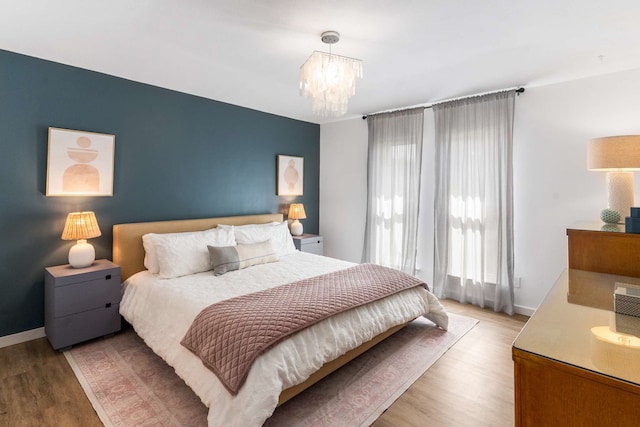 1236 Richland Oaks Dr, Richardson, TX 75081 - bedroom featuring wood finished floors, a chandelier, and baseboards