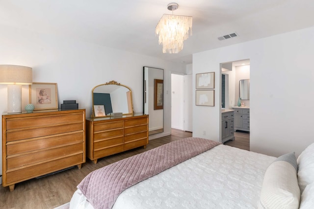 1236 Richland Oaks Dr, Richardson, TX 75081 - bedroom with a chandelier, wood finished floors, and ensuite bathroom