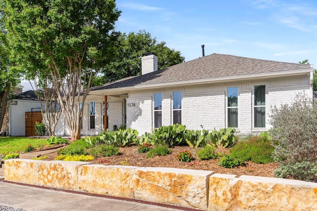 1236 Richland Oaks Dr, Richardson, TX 75081 - view of front facade featuring brick siding, a chimney, and roof with shingles