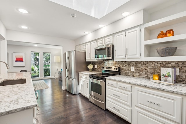 3121 Ponder Dr, Dallas, TX 75229 - kitchen featuring appliances with stainless steel finishes, a sink, white cabinets, decorative backsplash, and recessed lighting