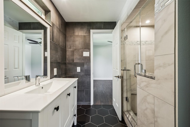 3121 Ponder Dr, Dallas, TX 75229 - bathroom with tile patterned floors, vanity, a stall shower, tile walls, and ceiling fan