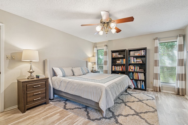 140 Amory Dr, Benbrook, TX 76126 - bedroom featuring wood finished floors, baseboards, a textured ceiling, and a ceiling fan
