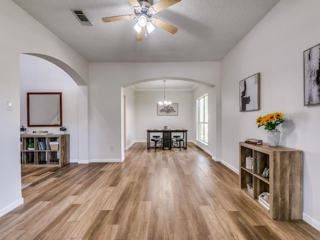 750 Pulitzer Ln, Allen, TX 75002 - hall with arched walkways, wood finished floors, a textured ceiling, baseboards, and a chandelier