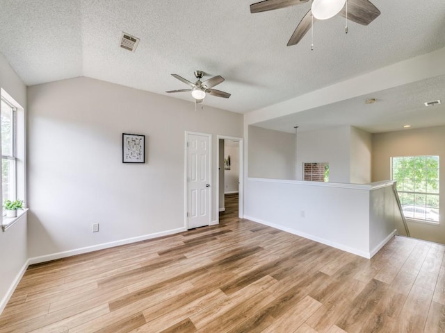 750 Pulitzer Ln, Allen, TX 75002 - empty room featuring ceiling fan, light wood-style floors, baseboards, a textured ceiling, and lofted ceiling