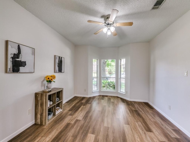 750 Pulitzer Ln, Allen, TX 75002 - unfurnished room with wood finished floors, ceiling fan, a textured ceiling, and baseboards