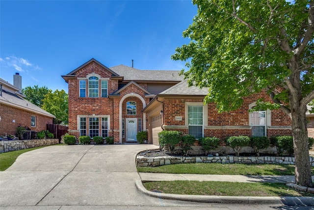 8405 White Stallion Trl, Mckinney, TX 75070 - traditional-style home with driveway, brick siding, an attached garage, and a shingled roof