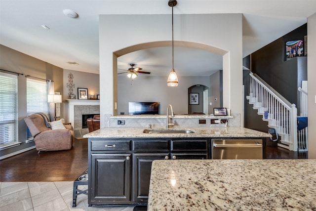 8405 White Stallion Trl, Mckinney, TX 75070 - kitchen featuring a sink, stainless steel dishwasher, open floor plan, arched walkways, and ceiling fan