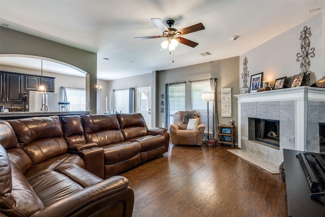 8405 White Stallion Trl, Mckinney, TX 75070 - living room featuring a ceiling fan, wood finished floors, healthy amount of natural light, and a tiled fireplace