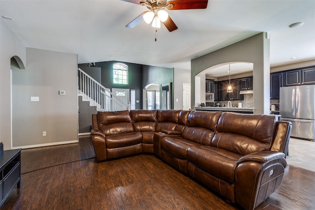 8405 White Stallion Trl, Mckinney, TX 75070 - living area featuring ceiling fan, arched walkways, wood finished floors, stairway, and baseboards