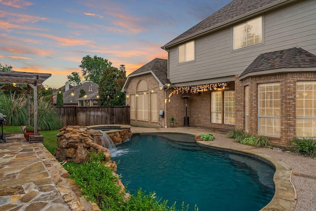 1912 White Oak Rd, Mckinney, TX 75072 - pool at dusk featuring a patio area, a fenced backyard, and a pool with connected hot tub