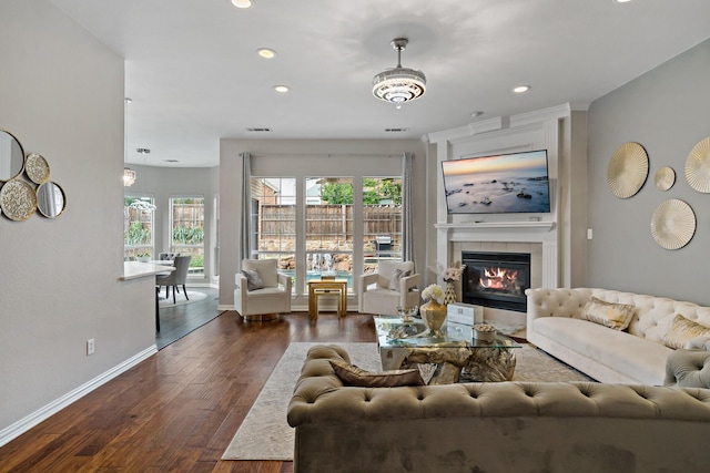 1912 White Oak Rd, Mckinney, TX 75072 - living area with baseboards, dark wood-style flooring, a tiled fireplace, and recessed lighting